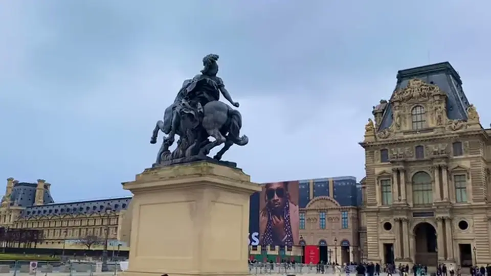 Equestrian statue in the Louvre courtyard with palace buildings behind