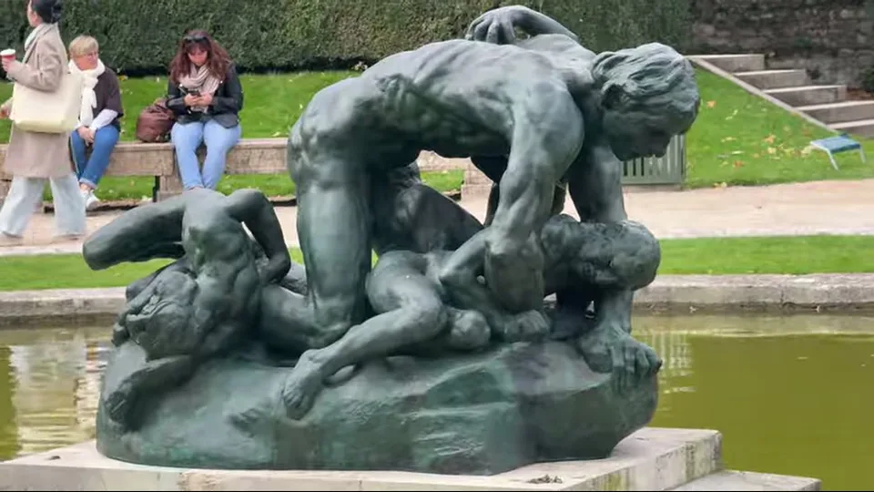 Three Shades sculpture in Musée Rodin garden with topiary and lawn